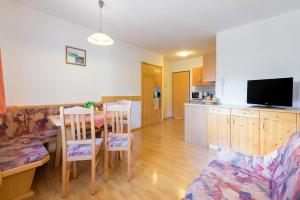 a kitchen and dining room with a table and chairs at Helis Appartements in Flachau