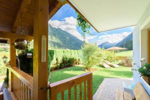 a porch of a house with a view of the mountains at Helis Appartements in Flachau