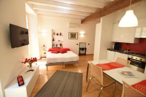 a bedroom with a bed with red pillows on it at Il Vicolo in Como