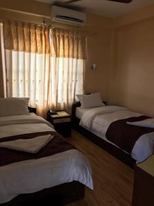 Ліжко або ліжка в номері Hotel Himalayan Inn