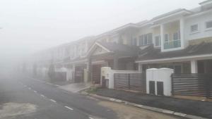 a row of houses on a street in the fog at Golden Hill in Cameron Highlands