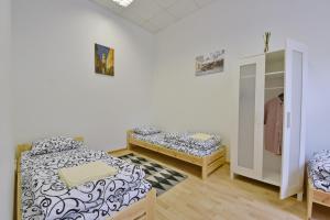 a bedroom with a bed and a desk at Laisves Avenue Hostel "Easy Kaunas" in Kaunas