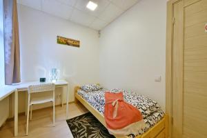a room with a bed, a table, and a window at Laisves Avenue Hostel "Easy Kaunas" in Kaunas