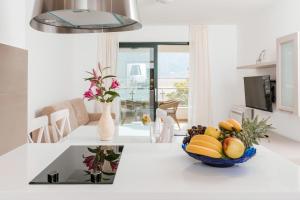 una cocina con un bol de fruta en una barra en Apartments Los Olivos, en Kotor