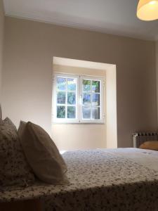 - une chambre avec un lit et une fenêtre dans l'établissement Casa dos Patricios, à Terras de Bouro