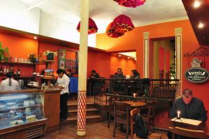 a restaurant with people sitting at tables and a counter at Hotel Naira in La Paz