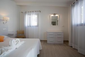 a white bedroom with a bed with towels on it at Hotel Rosamar - Emar Hotels in Es Pujols