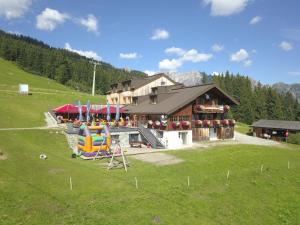 a large building with a playground in a field at Haus Matschwitz in Schruns