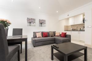 a living room with a couch and a table at Royal Princes Suites in Edinburgh