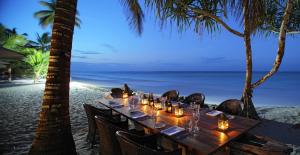 a table set up for a meal at a beach at Sultan Sands Island Resort in Kiwengwa