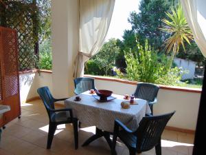 a table and chairs on a patio with a window at Villa Antonio Calderisi in Vieste