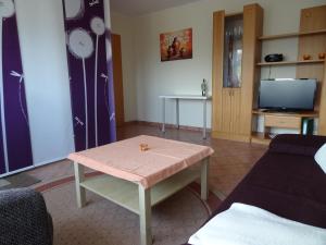 ein Wohnzimmer mit einem Tisch und einem TV in der Unterkunft Ferienwohnung Schneider in Mettlach