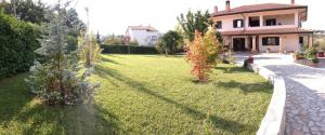 a house with a grassy yard with a fire hydrant at Cherry House Bed&Breakfast in Campobasso +5 photos