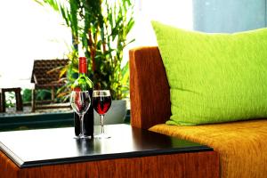 a bottle of wine and two glasses on a table at Randiya Beach Villa in Galle