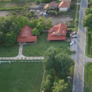 an aerial view of two houses with red roofs at Pálya Vendégház in Pusztaszer
