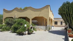 a building with a lot of plants in a courtyard at Villa Alba in Valderice