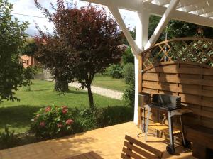 a patio with a grill and a table with a stove at La Bulle in Audenge