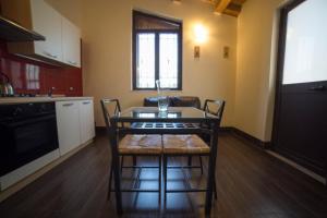 eine Küche mit einem Tisch und Stühlen im Zimmer in der Unterkunft Red Orange Catania Ognina in Catania