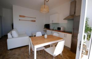 a kitchen and dining room with a table and chairs at El Aceitun Beach Holiday Homes in Gran Tarajal