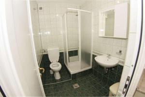 a bathroom with a shower and a toilet and a sink at Apartments Simovic in Tučepi +61 photos
