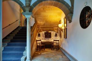 
a room with a staircase leading to a dining room at Parador de Ubeda in Úbeda
