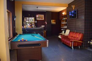 a billiard room with a pool table and a couch at Hotel Saint-Jean in Cotonou