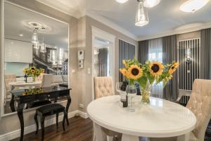 jadalnia z białym stołem i kwiatami w obiekcie Luxury Apartments - Wroclaw Old Town - Wrocław Rynek we Wrocławiu