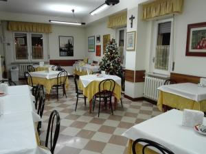 a dining room with tables and a christmas tree at Albergo Roma in Lanciano