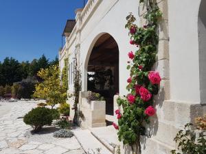 ein Gebäude mit Rosen an der Seite in der Unterkunft Le Scuderie - Castello Monaci in Salice Salentino