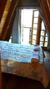 a bed in a room with a window at Tierra Mandarina Cabañas in Gualeguaychú +68 photos