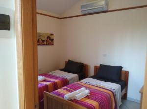 a small room with two beds and a mirror at Pomos Harbourbiew Villa in Pomos