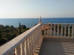 a white balcony with a view of the ocean at Pomos Harbourbiew Villa in Pomos
