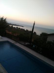 a swimming pool with a view of the ocean at Pomos Harbourbiew Villa in Pomos