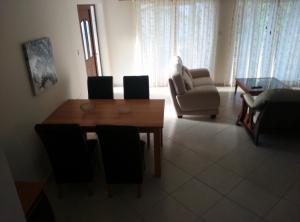 a living room with a wooden table and a chair at Pomos Harbourbiew Villa in Pomos