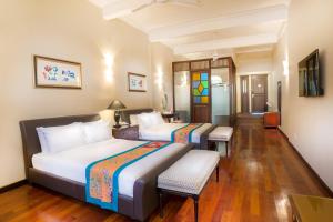 a hotel room with two beds and a table at Areca Hotel Penang in George Town +65 photos