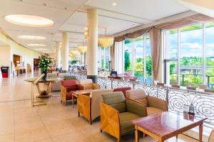 a lobby of a hotel with chairs and tables and windows at The Celecton Premier Kobe Sanda Hotel in Sanda