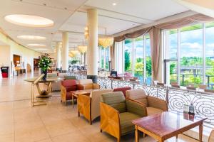 a lobby of a hotel with chairs and tables and windows at The Celecton Premier Kobe Sanda Hotel in Sanda