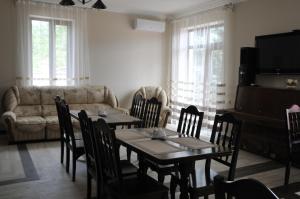 a living room with a table and chairs and a couch at Dom Fedorovyh in Sergeyevka