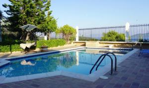 a swimming pool with a stairway leading to a pool at Maisonette Ilios in Korfos