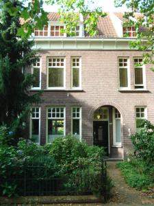 a brick house with a gate in front of it at Boutiquehotel Sycamore - Protected City View - 950m from Central Station in Eindhoven