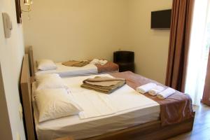 Postel nebo postele na pokoji v ubytování Hotel Kolkhi Shekvetili