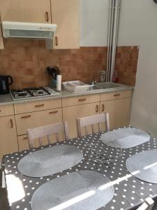 a kitchen with a table with plates on it at L'instant Sarladais in Sarlat-la-Canéda +18 photos