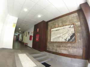 a hallway in a building with a painting on the wall at Loft Canteras in Las Palmas de Gran Canaria