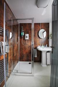 a bathroom with a shower and a sink at Seaforth Cottage -Dog friendly, Historical Fishertown, central location in Nairn