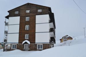 a building in the snow with snow around it at Iceberg Loft in Gudauri