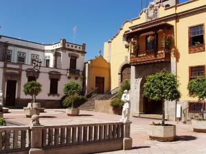 a building with a statue in the middle of a courtyard at Hotel Drago San Antonio in Icod de los Vinos