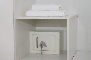 a white shelf with towels and an umbrella on it at Hotel Drago San Antonio in Icod de los Vinos