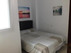 A bed or beds in a room at Apartamento Playa Las Canteras