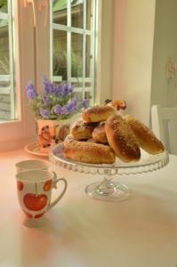 a plate of pastries on a table with a cup of coffee at Chata Dziadka Ignacego in Augustów