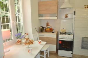 a kitchen with a table and a stove top oven at Chata Dziadka Ignacego in Augustów